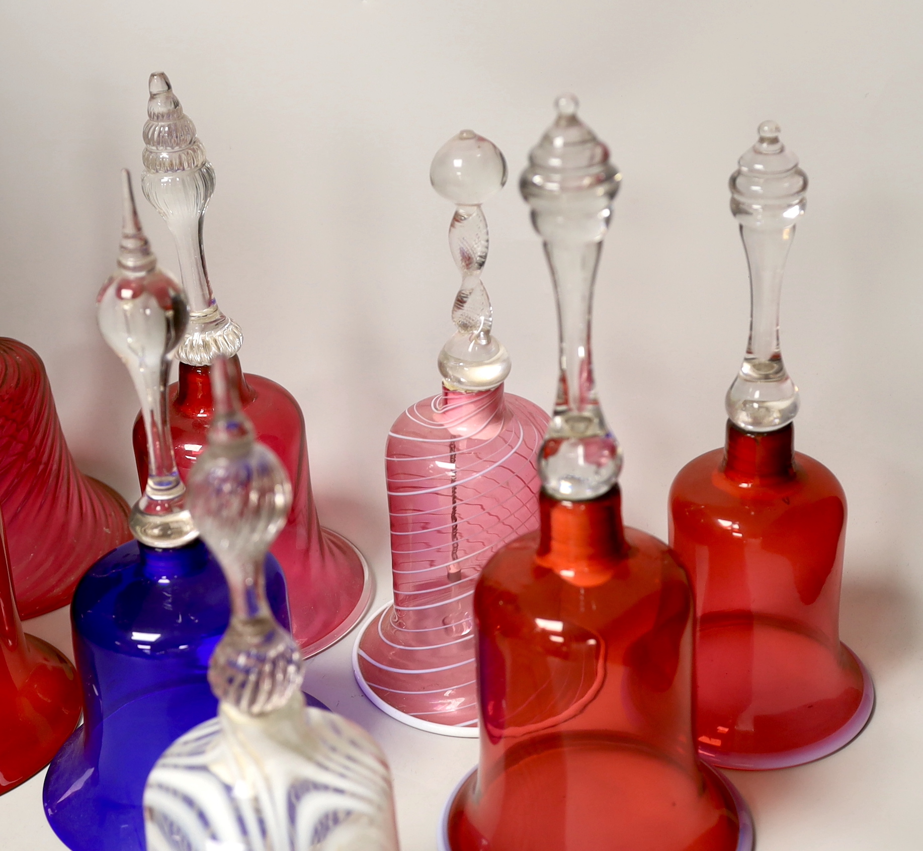 Eight Victorian coloured glass hand bells, tallest 34cm